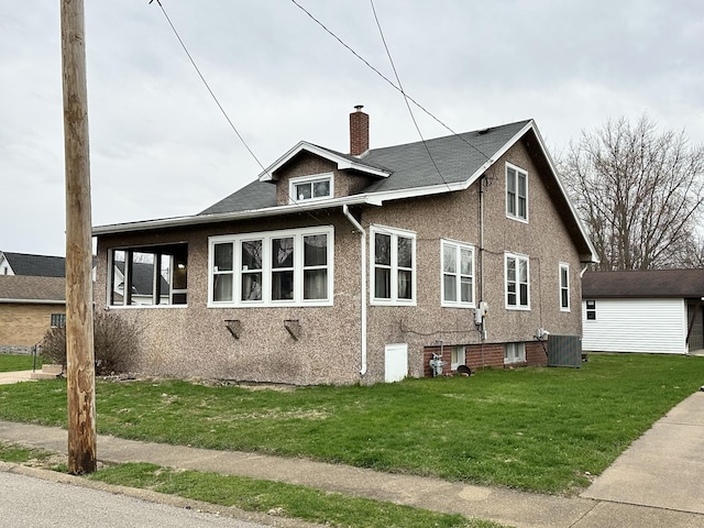view of property exterior featuring central AC, a chimney, and a lawn
