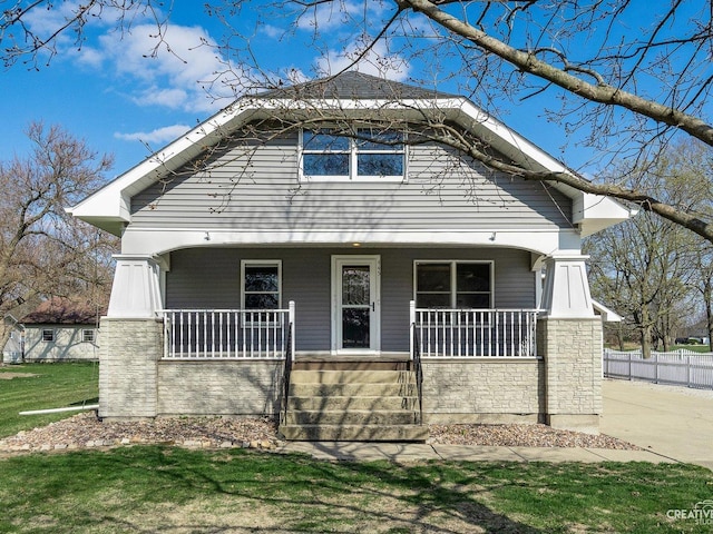 445 S Depot St, Somonauk, IL 60552 - view of front facade with a porch, stone siding, and a front lawn