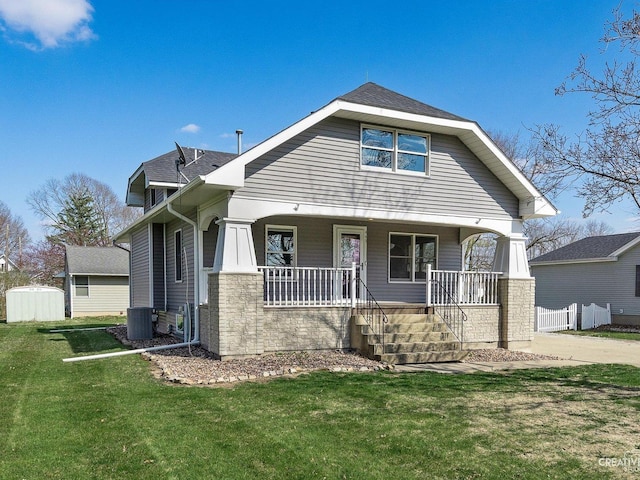 445 S Depot St, Somonauk, IL 60552 - view of front facade with a porch, stone siding, a front lawn, and cooling unit