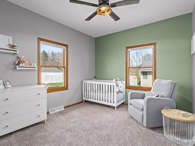 445 S Depot St, Somonauk, IL 60552 - carpeted bedroom featuring a nursery area, visible vents, baseboards, and a ceiling fan