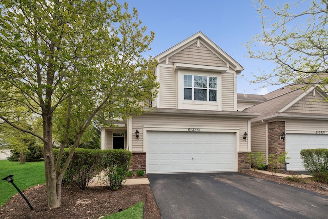 view of front facade featuring stone siding, aphalt driveway, and an attached garage