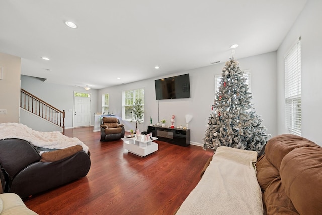 living room featuring baseboards, stairs, recessed lighting, and dark wood-style flooring