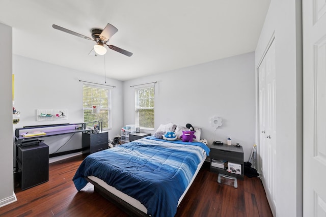 bedroom with a closet, a ceiling fan, and wood finished floors
