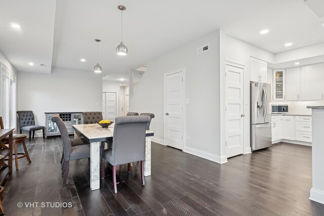 dining area with visible vents, recessed lighting, dark wood finished floors, and baseboards