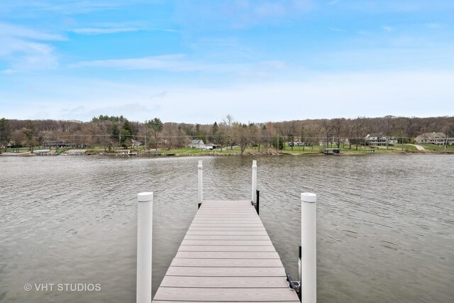dock area featuring a water view and a forest view