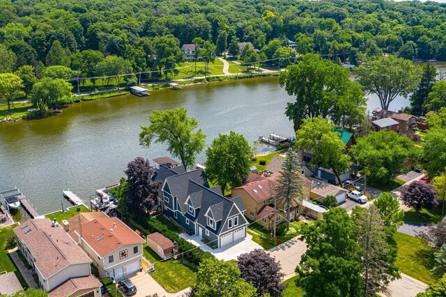 drone / aerial view featuring a water view and a residential view