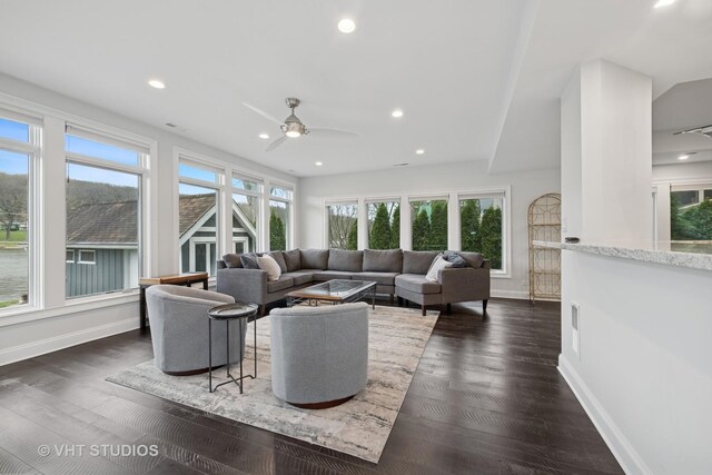 living area featuring baseboards, ceiling fan, recessed lighting, and dark wood-type flooring