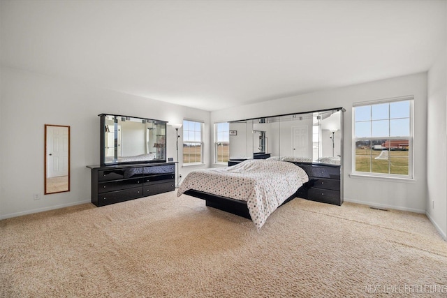 bedroom featuring carpet flooring, visible vents, and baseboards