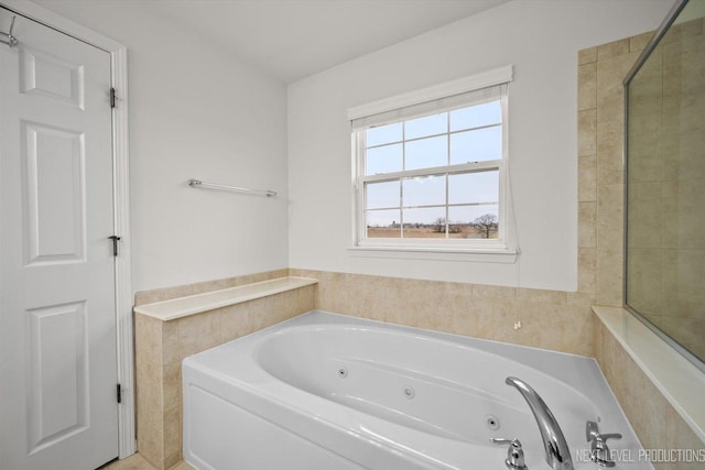full bath with a whirlpool tub and tile walls