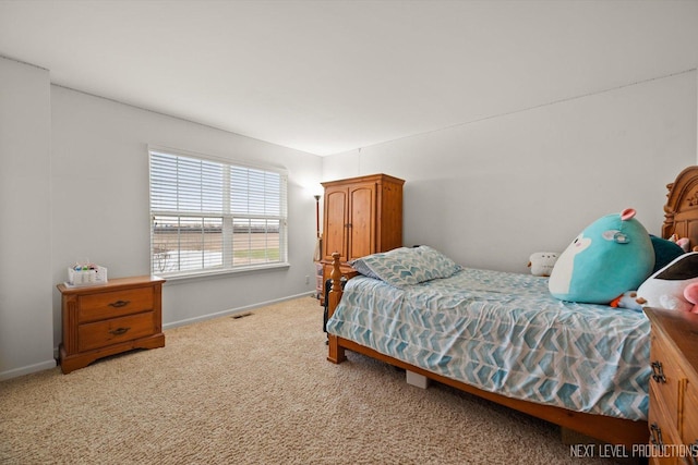 carpeted bedroom with visible vents and baseboards