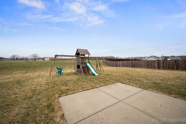 view of playground with fence and a lawn