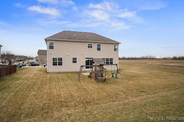 rear view of house with a lawn