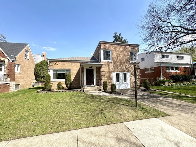view of front of property with a front lawn, brick siding, and concrete driveway