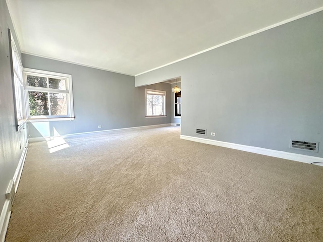 empty room with baseboards, visible vents, an inviting chandelier, and carpet flooring