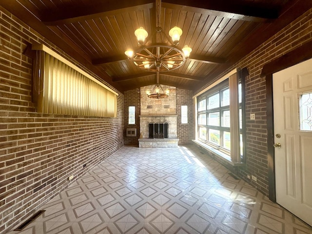 unfurnished living room featuring tile patterned floors, wood ceiling, brick wall, and an inviting chandelier