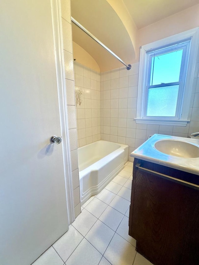 bathroom featuring tile walls, tile patterned floors, shower / bathtub combination, and vanity