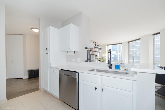 222 N Columbus Dr Unit 1509, Chicago, IL 60601 - kitchen featuring white cabinets, light countertops, dishwasher, a sink, and light tile patterned flooring