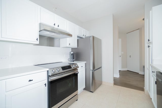 222 N Columbus Dr Unit 1509, Chicago, IL 60601 - kitchen with white cabinets, under cabinet range hood, stainless steel appliances, light countertops, and baseboards