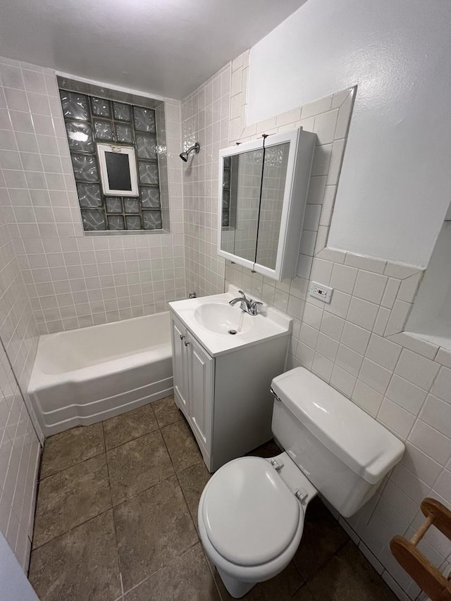 full bath with bathtub / shower combination, vanity, toilet, tile walls, and tile patterned floors