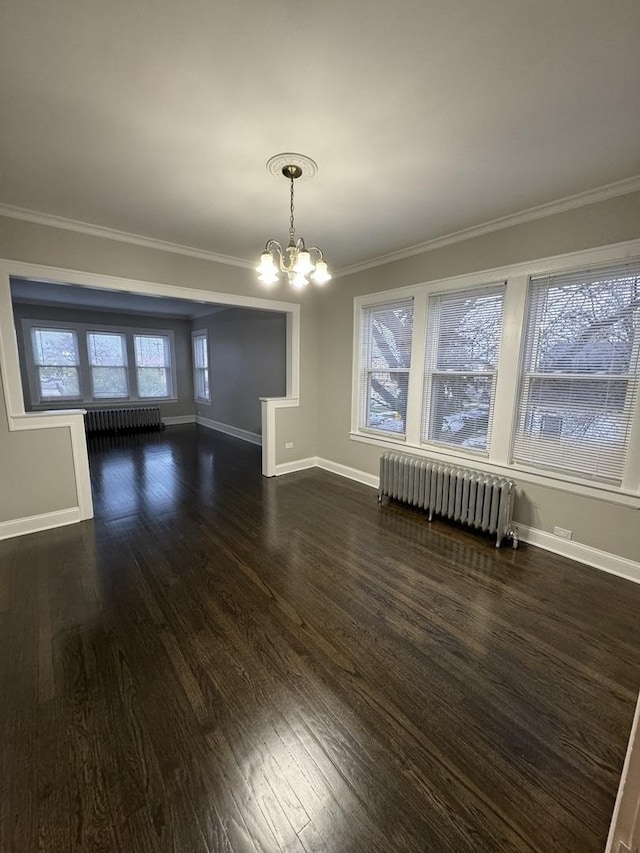 unfurnished dining area with baseboards, a notable chandelier, dark wood-style flooring, ornamental molding, and radiator heating unit
