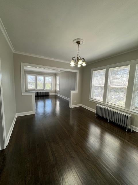 unfurnished dining area with ornamental molding, radiator heating unit, a notable chandelier, and baseboards