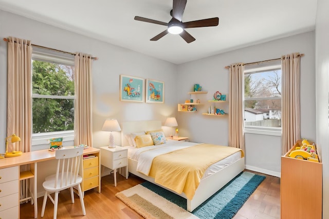 bedroom featuring light wood-type flooring and a ceiling fan