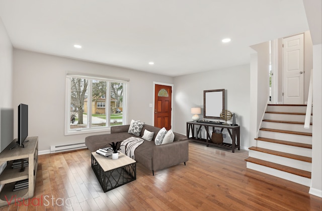 living room with baseboard heating, wood finished floors, recessed lighting, and stairs