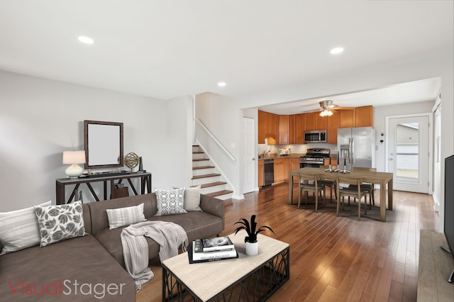 living room featuring recessed lighting, dark wood-style flooring, a ceiling fan, and stairway