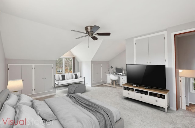 bedroom with ceiling fan, light colored carpet, vaulted ceiling, and baseboards