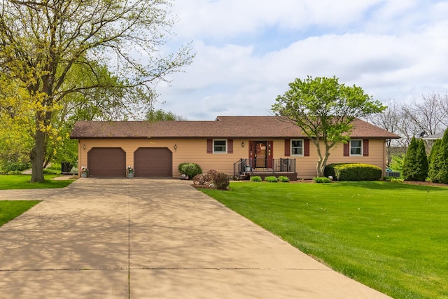 3449 E Cleveland St, Ladd, IL 61329 - ranch-style home featuring concrete driveway, an attached garage, and a front yard