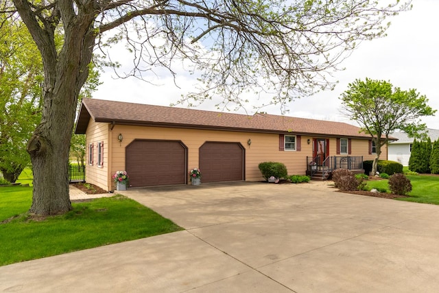 3449 E Cleveland St, Ladd, IL 61329 - single story home with a front yard, driveway, fence, and a garage