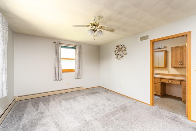 3449 E Cleveland St, Ladd, IL 61329 - unfurnished bedroom with light carpet, baseboards, a baseboard radiator, and visible vents