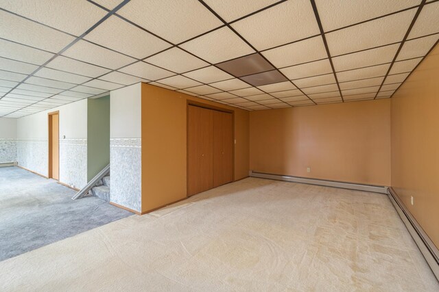 3449 E Cleveland St, Ladd, IL 61329 - below grade area featuring a paneled ceiling, a baseboard radiator, a wainscoted wall, and carpet floors