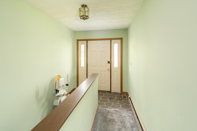 3449 E Cleveland St, Ladd, IL 61329 - doorway with baseboards, dark carpet, and a baseboard radiator