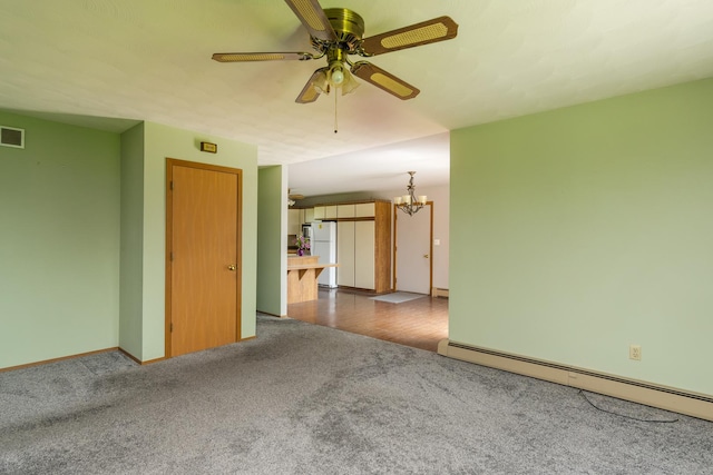 3449 E Cleveland St, Ladd, IL 61329 - unfurnished room with a baseboard radiator, baseboards, carpet flooring, visible vents, and ceiling fan with notable chandelier