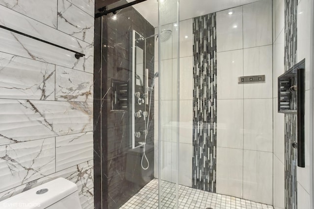 full bath with tile walls, toilet, and a stall shower