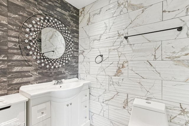 bathroom featuring tile walls, toilet, and vanity