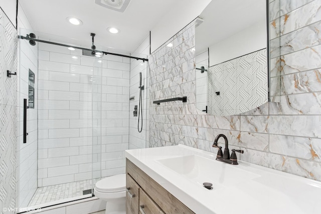 bathroom with toilet, tile walls, a shower stall, and a baseboard heating unit