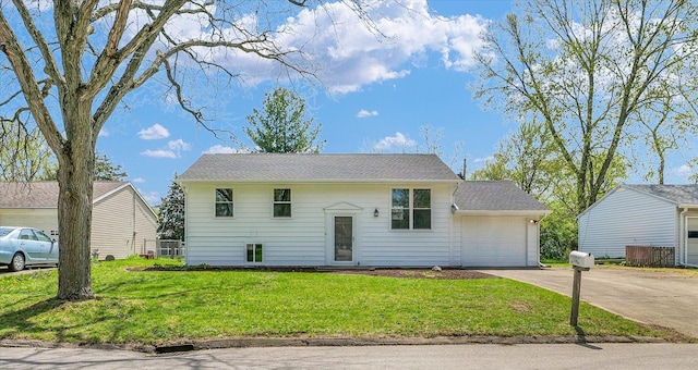 split foyer home featuring a front lawn, driveway, and a garage