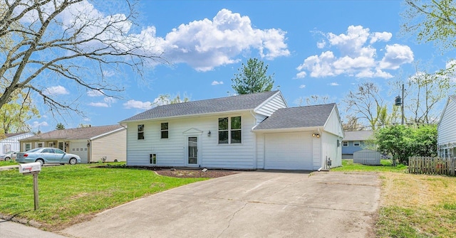 view of front of home featuring an attached garage, driveway, a shingled roof, and a front lawn