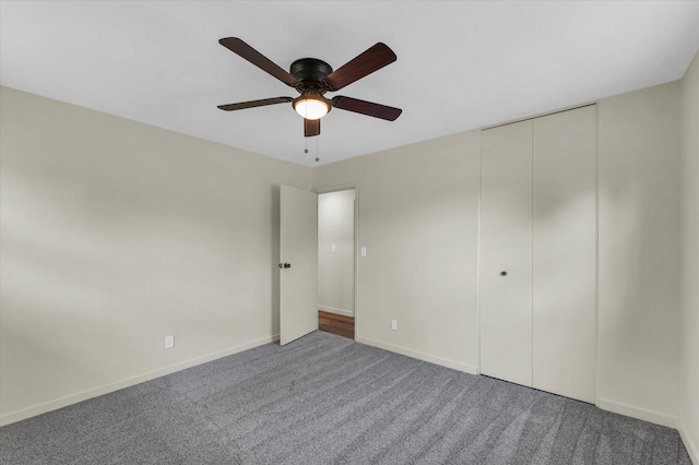 unfurnished bedroom featuring baseboards, carpet flooring, a closet, and ceiling fan