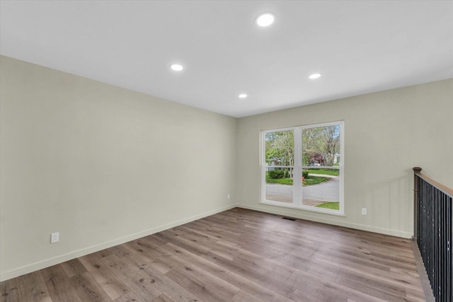 interior space featuring recessed lighting, wood finished floors, visible vents, and baseboards