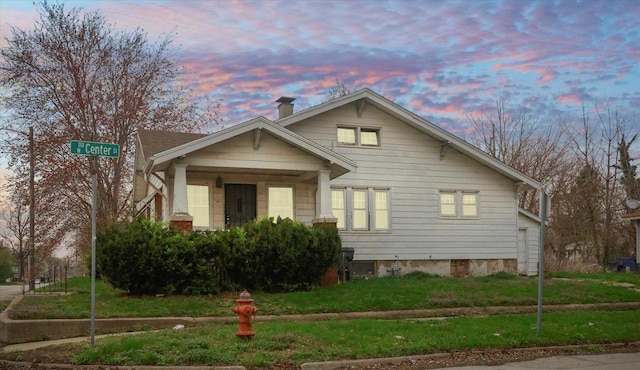 view of side of home featuring a lawn
