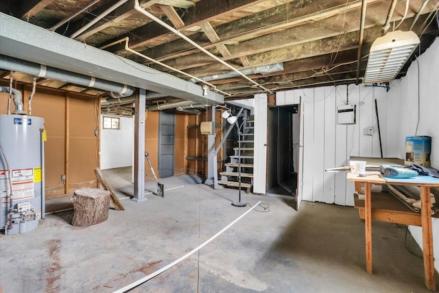 basement with water heater and stairs