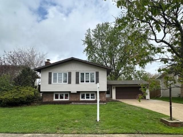 6140 El Morro Ln, Oak Forest, IL 60452 - split level home with a garage, concrete driveway, a front yard, and a chimney