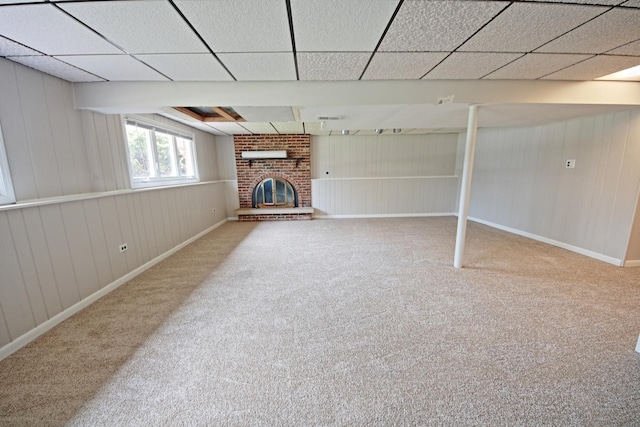 6140 El Morro Ln, Oak Forest, IL 60452 - unfurnished living room with carpet, a brick fireplace, baseboards, wood walls, and a drop ceiling