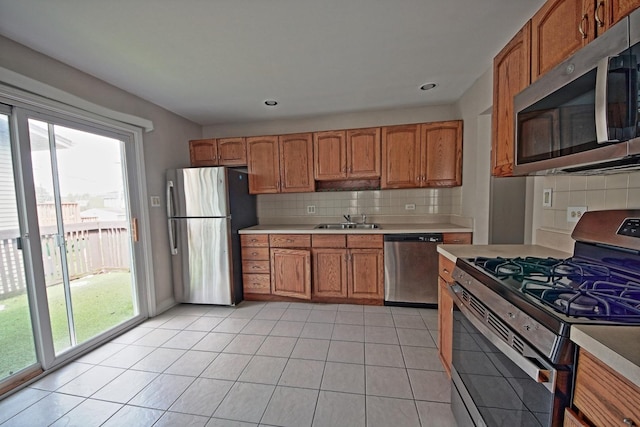 6140 El Morro Ln, Oak Forest, IL 60452 - kitchen with stainless steel appliances, a sink, light countertops, backsplash, and recessed lighting