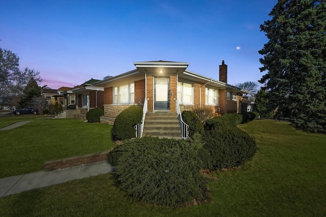 view of home's exterior with a yard, brick siding, and a chimney