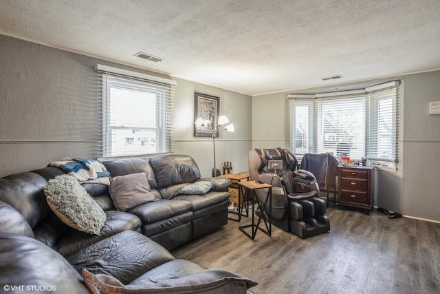 28 S Illinois Ave, Villa Park, IL 60181 - living room with a textured ceiling, visible vents, wood finished floors, wainscoting, and a textured wall