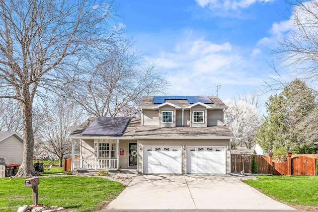 traditional home featuring roof mounted solar panels, driveway, a front lawn, and covered porch